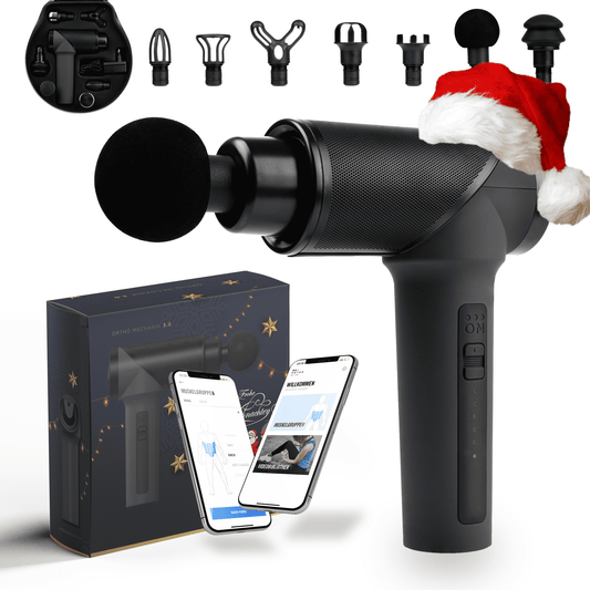 Weihnachts-Edition OrthoMechanik 3.0 Massagepistole mit Aufsätzen und Verpackung.