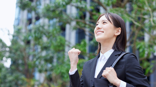 Erfolgreiche Geschäftsfrau mit gerader Haltung feiert beruflichen Erfolg im Freien.